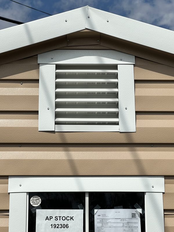 12×12-Vent-600×800 Portable building exterior featuring a white vent and beige siding, showcasing customization options for sheds and storage solutions by Repo Lot.
