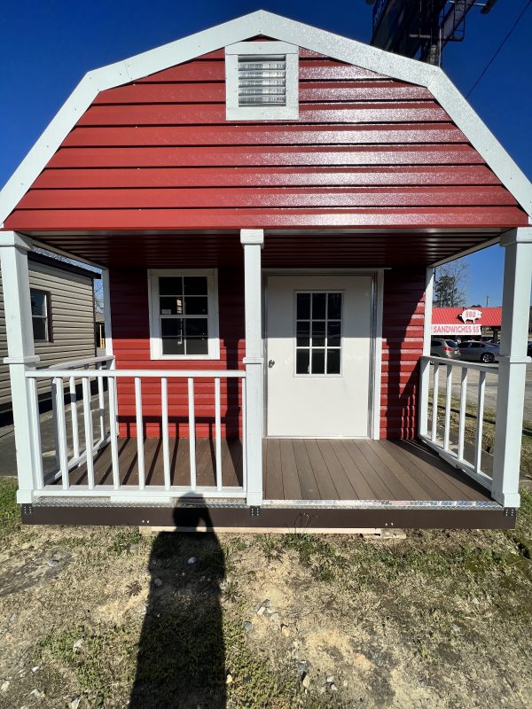 12×4-Deck-with-Railing-600×800 Red portable storage building with a front porch and white railing, featuring a door and windows, showcasing customizable design options for sheds by Repo Lot.