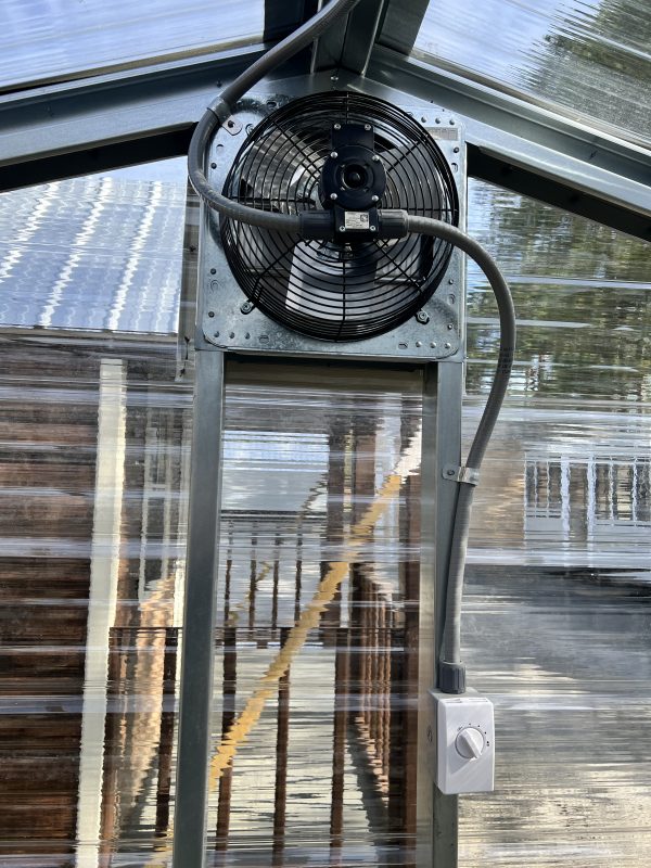 16-Exhaust-Fan-with-Guard-Automatic-Shutter-Thermostat-and-Switch-600×800 Exhaust fan with guard and thermostat installed in a portable building, showcasing ventilation options for customizable sheds.