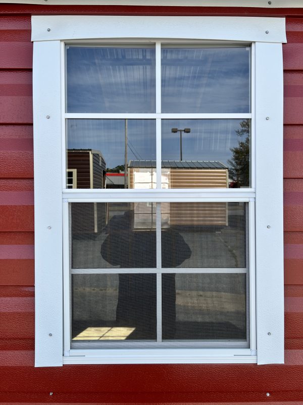 22×36-Large-Window-600×800 Large window with white trim on red portable building, showcasing customizable features and reflections of nearby storage units.
