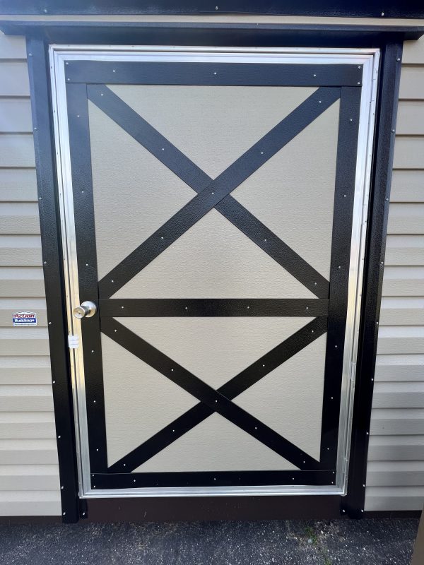 46×72-Single-Door-XBrace-600×800 X-braced single door of a portable storage building with a sleek black frame and handle, showcasing customizable design options for sheds offered by Repo Lot.