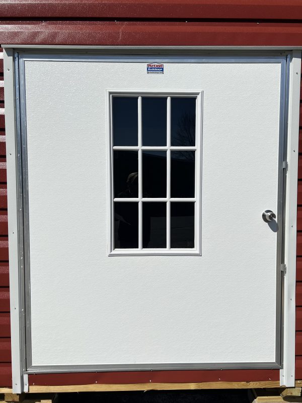 60×72-Single-Door-w-9-Light-600×800 White single door with nine-light window, framed in silver, on a portable storage building with red siding, showcasing customizable features for sheds.
