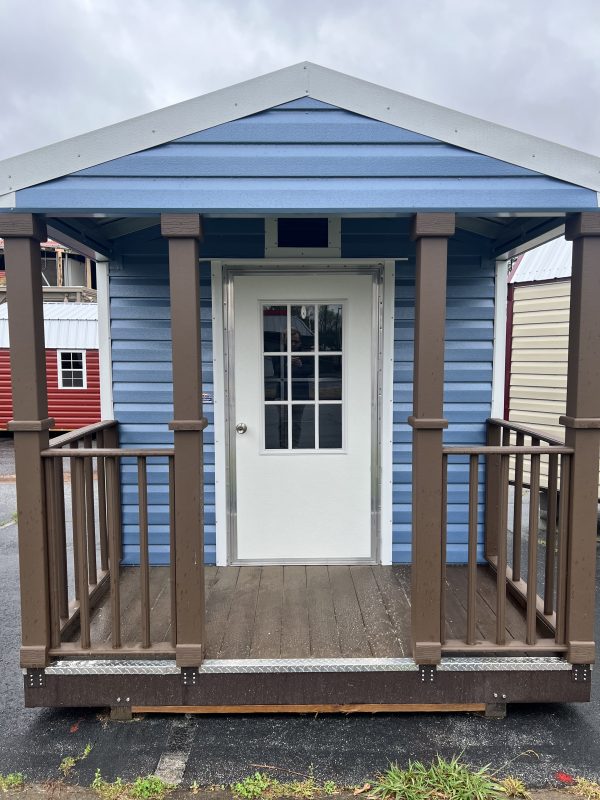 8×4-Deck-with-Railing-600×800 Portable blue storage building with white door and brown railing, showcasing customizable features for outdoor storage solutions.