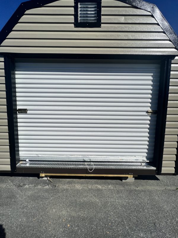 9×6-Rollup-Door-600×800 Portable storage building featuring a roll-up door, customizable siding, and a decorative roof vent, showcasing options for portable sheds by Repo Lot.