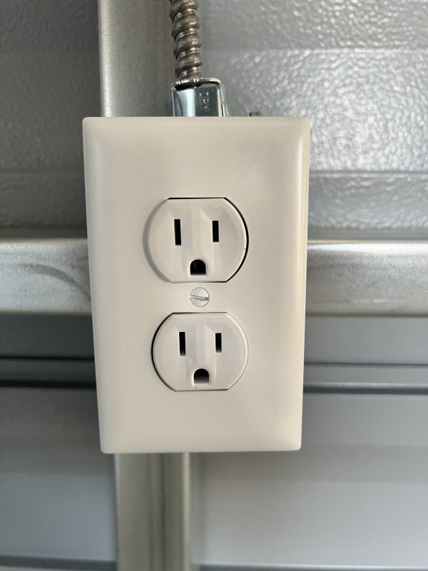 Outlet-600×800 Electrical outlet featuring two sockets mounted on a wall, relevant to customizable portable buildings and sheds by Repo Lot.