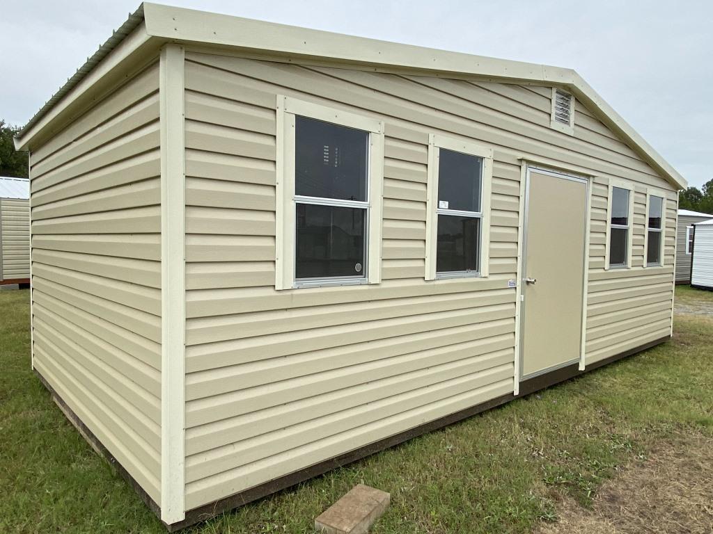 Side gable portable cabin with beige exterior, multiple windows, and a front door, showcasing versatility for storage or workspace applications.