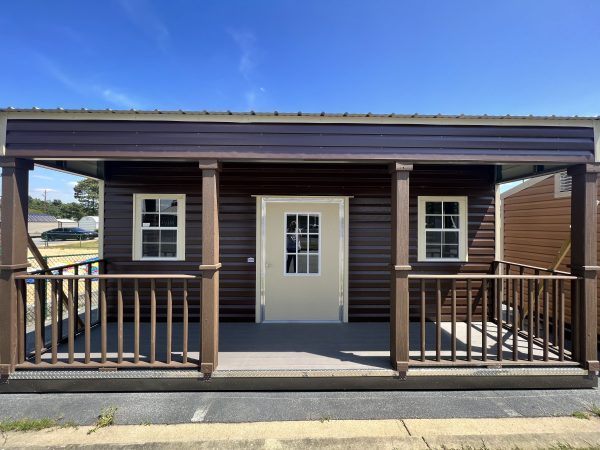 Side-Porch-600×450 Portable storage building with a brown exterior, front porch, and white door, showcasing customization options for sheds and buildings by Repo Lot.