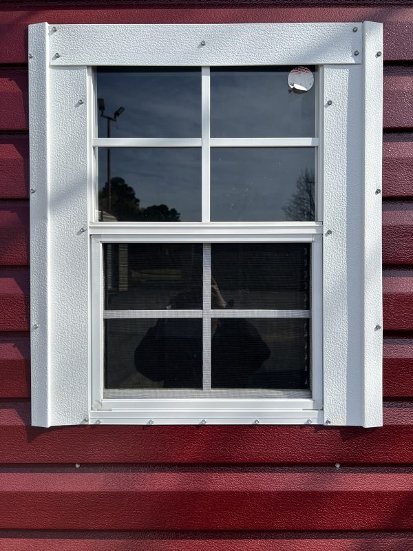 Small-18×27-Window-600×800 Window with white trim on a red portable storage building, showcasing customizable design options for sheds.