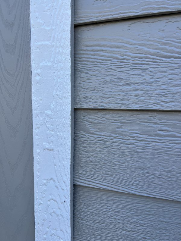 Smart-Trim-600×800 Close-up of portable building siding and white trim, showcasing customizable features for sheds and storage solutions by Repo Lot.